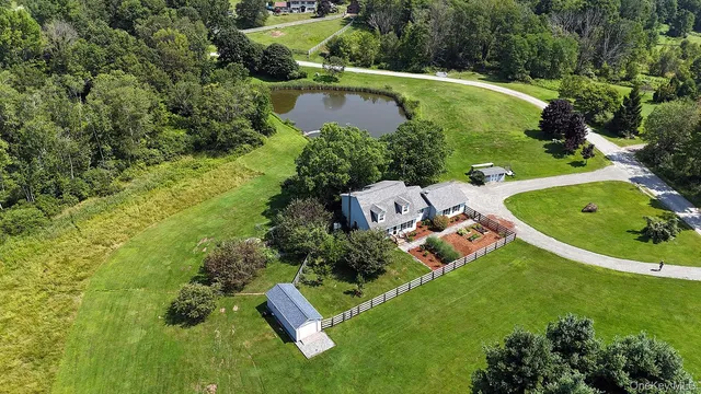 an aerial view of a house with a yard