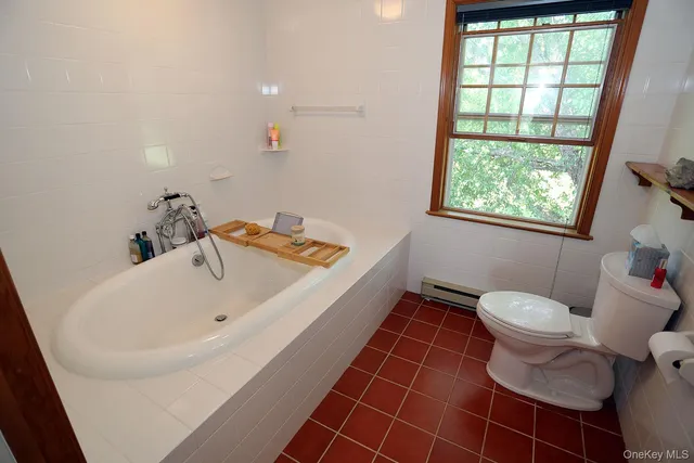 a bathroom with a sink toilet and window