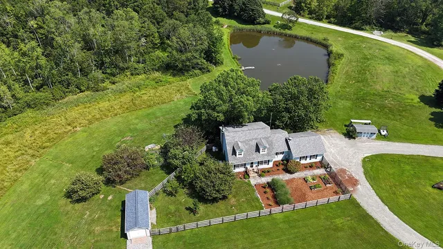 an aerial view of a house with a yard basket ball court and outdoor seating