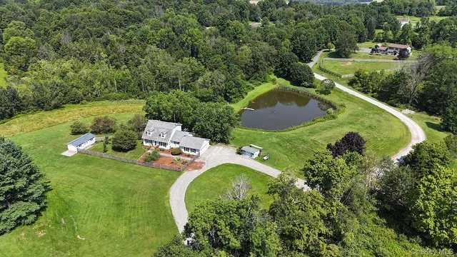 an aerial view of a house with yard swimming pool and outdoor seating