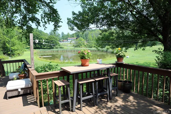 a view of a deck with furniture and garden