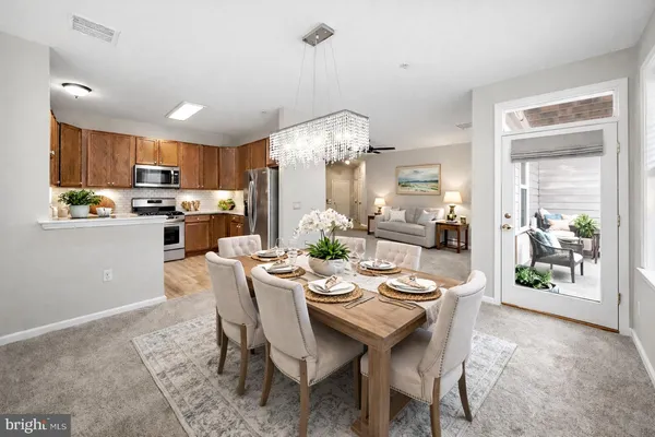 a view of a dining room with furniture and chandelier