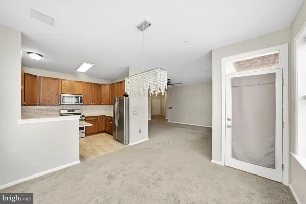 a view of a kitchen and a refrigerator a microwave