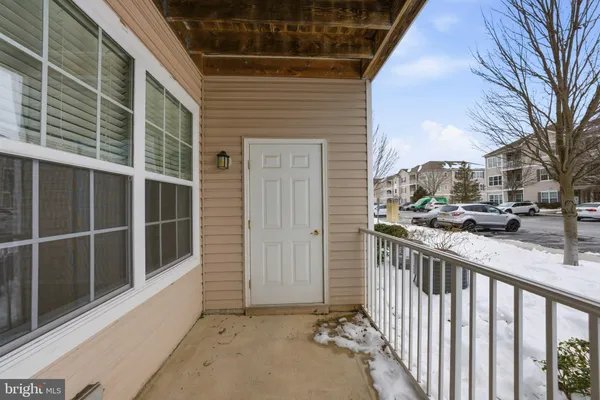a view of a balcony with a potted plant and a window