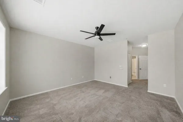 a view of a room with a ceiling fan