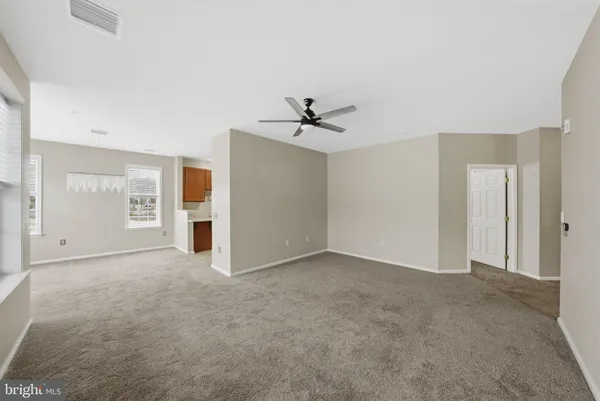 an empty room with closet and windows