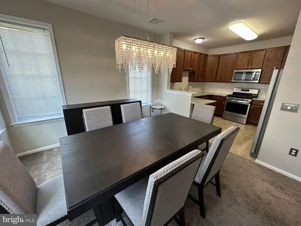 a view of kitchen with cabinets table and chairs