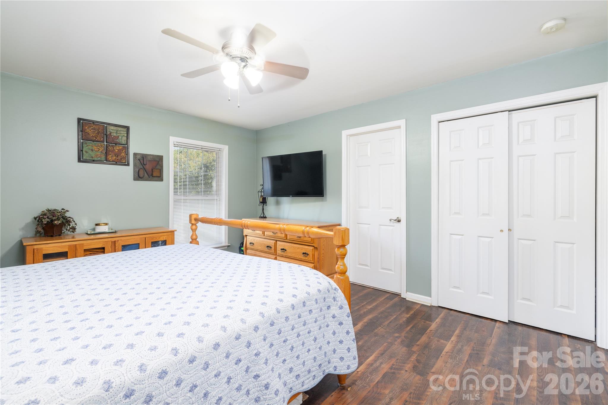 638 Acorn Acres Road Norwood, NC 28128 - Photo 11 of 23 a bedroom with a bed and a chandelier