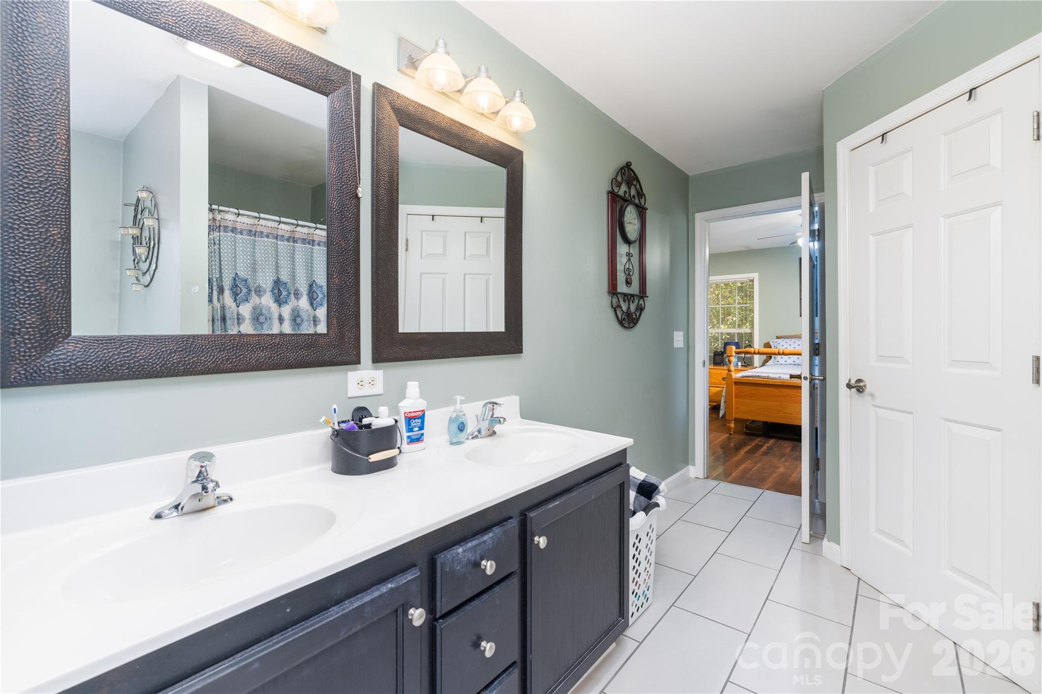 638 Acorn Acres Road Norwood, NC 28128 - Photo 13 of 23 a en suite bathroom with a double vanity sink and a mirror