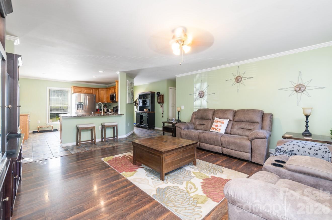 638 Acorn Acres Road Norwood, NC 28128 - Photo 15 of 23 a living room with couches and kitchen view with wooden floor