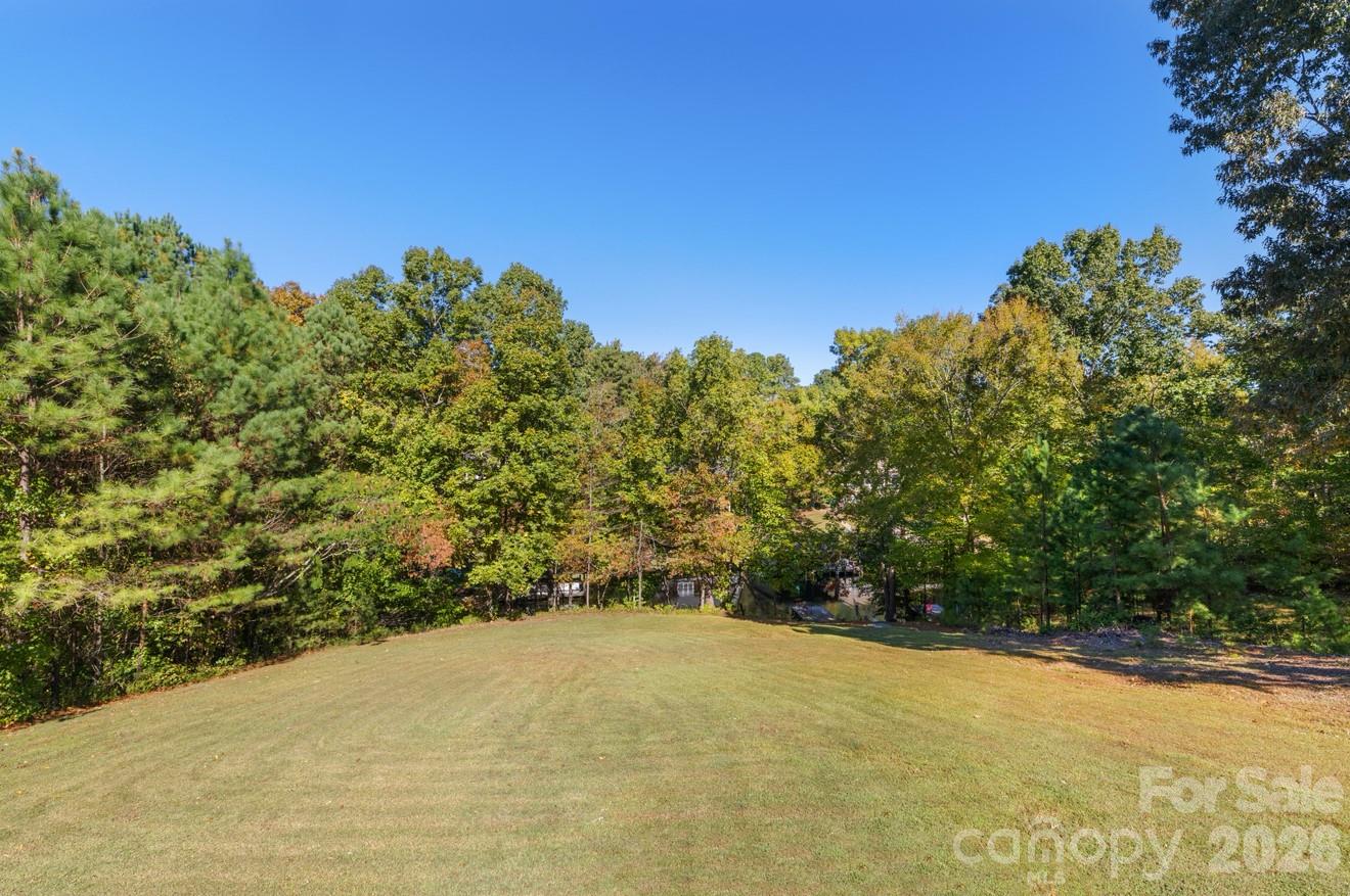 638 Acorn Acres Road Norwood, NC 28128 - Photo 21 of 23 a view of a big yard with plants and large trees