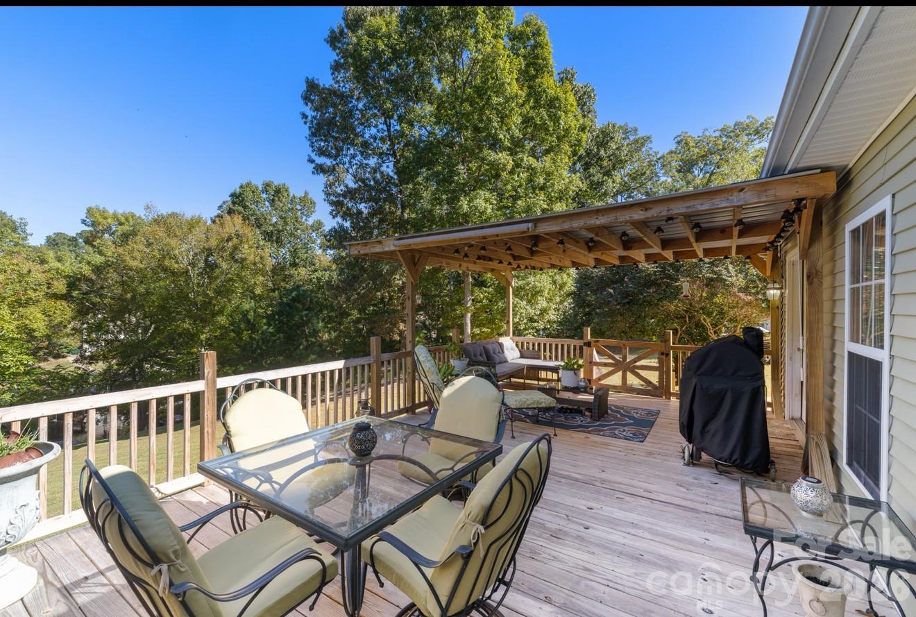 638 Acorn Acres Road Norwood, NC 28128 - Photo 22 of 23 a view of a chair and tables in the balcony