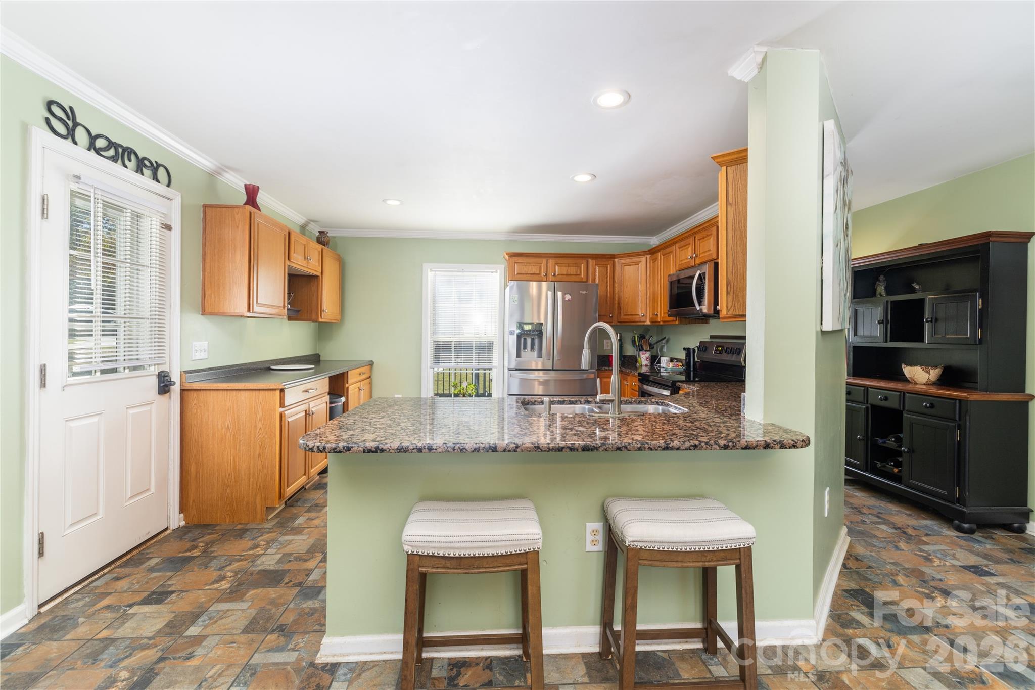 638 Acorn Acres Road Norwood, NC 28128 - Photo 6 of 23 a kitchen with a dining table chairs sink and cabinets