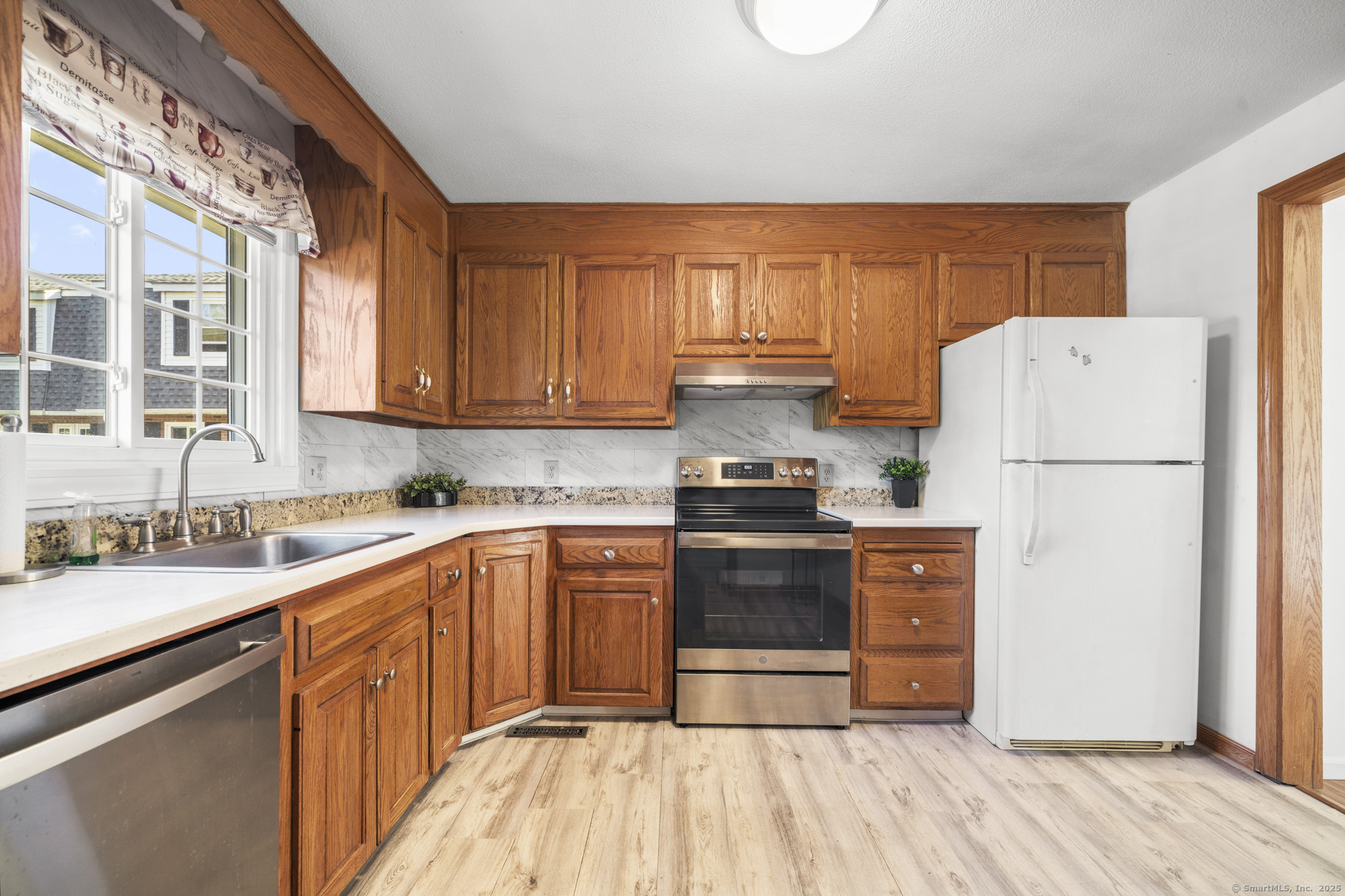 1165 Enfield Street, Unit 11 Enfield, CT 06082 - Photo 3 of 30 a kitchen with stainless steel appliances granite countertop a refrigerator sink and stove