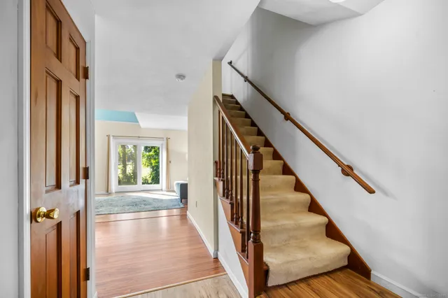 a view of an entryway with wooden floor and stairs