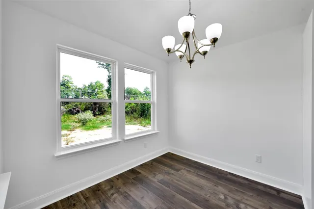 a view of a chandelier fan and wooden floor