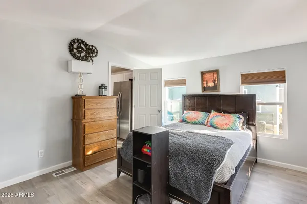 a bedroom with a bed and a desk