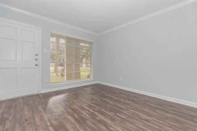 a view of empty room with wooden floor and cabinet