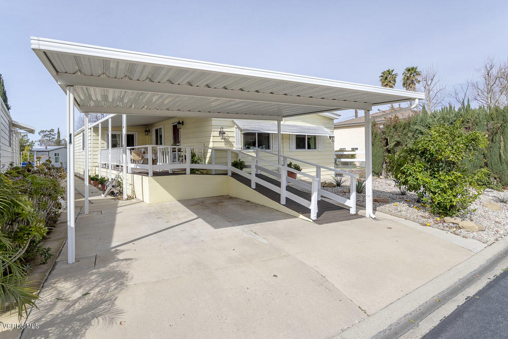 6480 Katherine Road, Unit 1 Simi Valley, CA 93063 - Photo 3 of 23 a view of a patio with table and chairs potted plants and floor to ceiling window