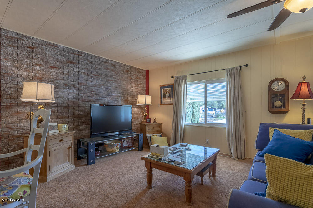 6480 Katherine Road, Unit 1 Simi Valley, CA 93063 - Photo 7 of 23 a living room with furniture and a flat screen tv