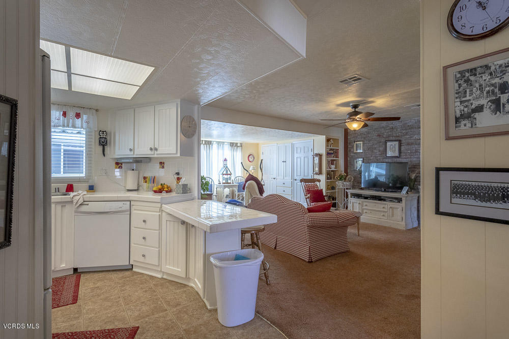 6480 Katherine Road, Unit 1 Simi Valley, CA 93063 - Photo 9 of 23 a living room with furniture white walls and kitchen view