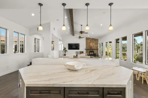 a view of a kitchen with kitchen island a large island in it