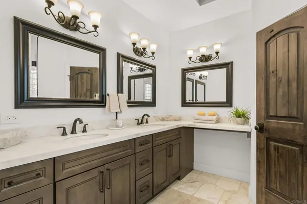 a bathroom with a double vanity sink mirror and