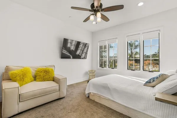 a bedroom with a bed couch and window