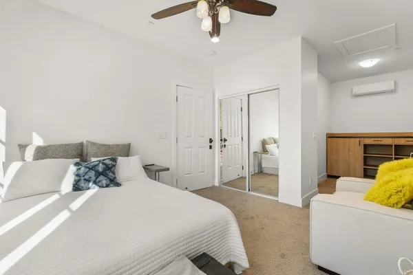 a bedroom with a bed and a couch