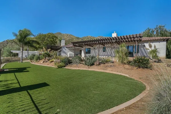 a front view of a house with a garden