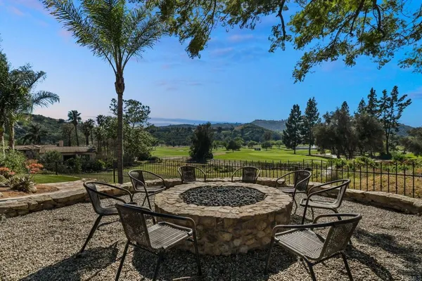 a view of a chairs and table in patio