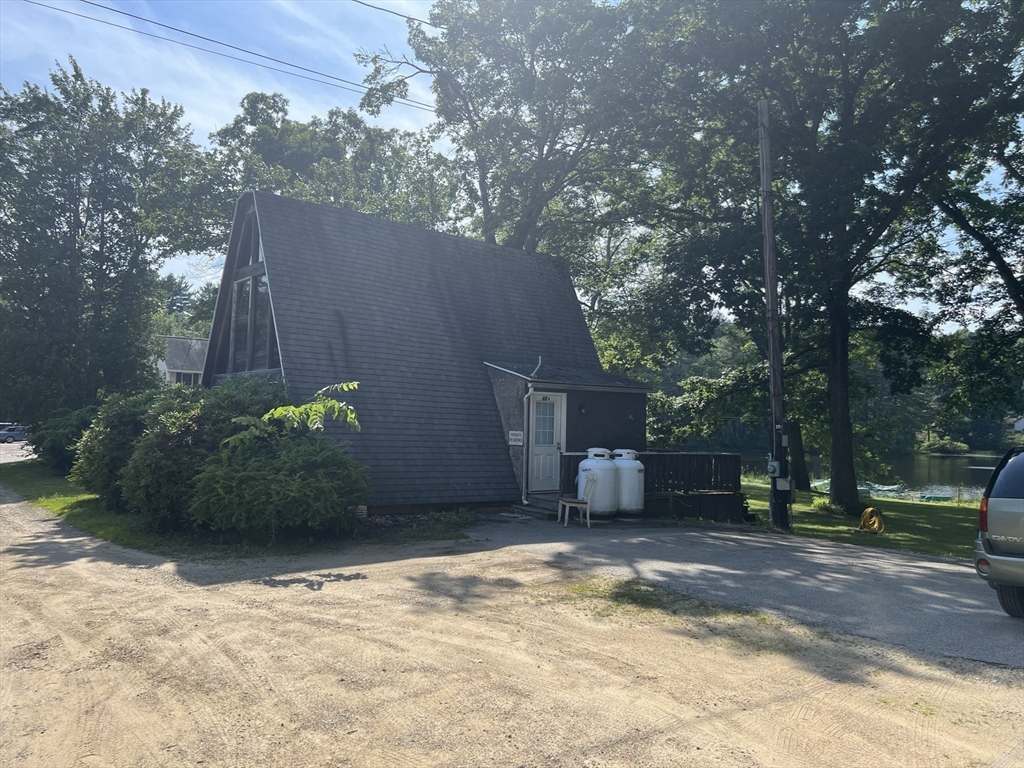68-74 Sturbridge Road Charlton, MA 01507 - Photo 10 of 41 a view of a backyard with potted plants and large trees