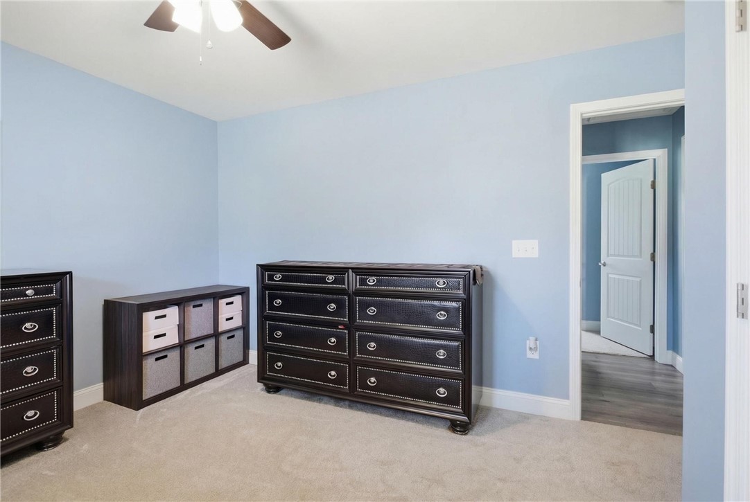 745 Dave Nix Road Seneca, SC 29678 - Photo 15 of 23 A well-lit bedroom features plush carpeting and a convenient ceiling fan.