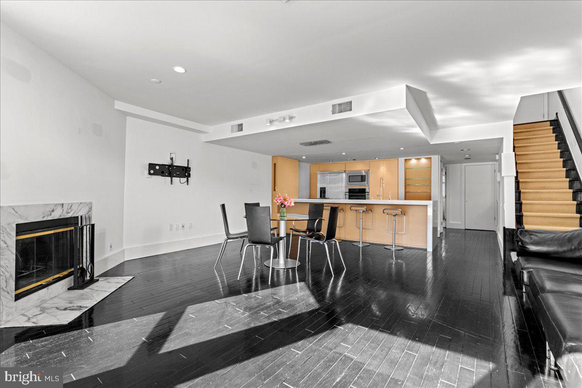 350 River Road, Unit D10 New Hope, PA 18938 - Photo 11 of 41 a living room with furniture a fireplace and a flat screen tv