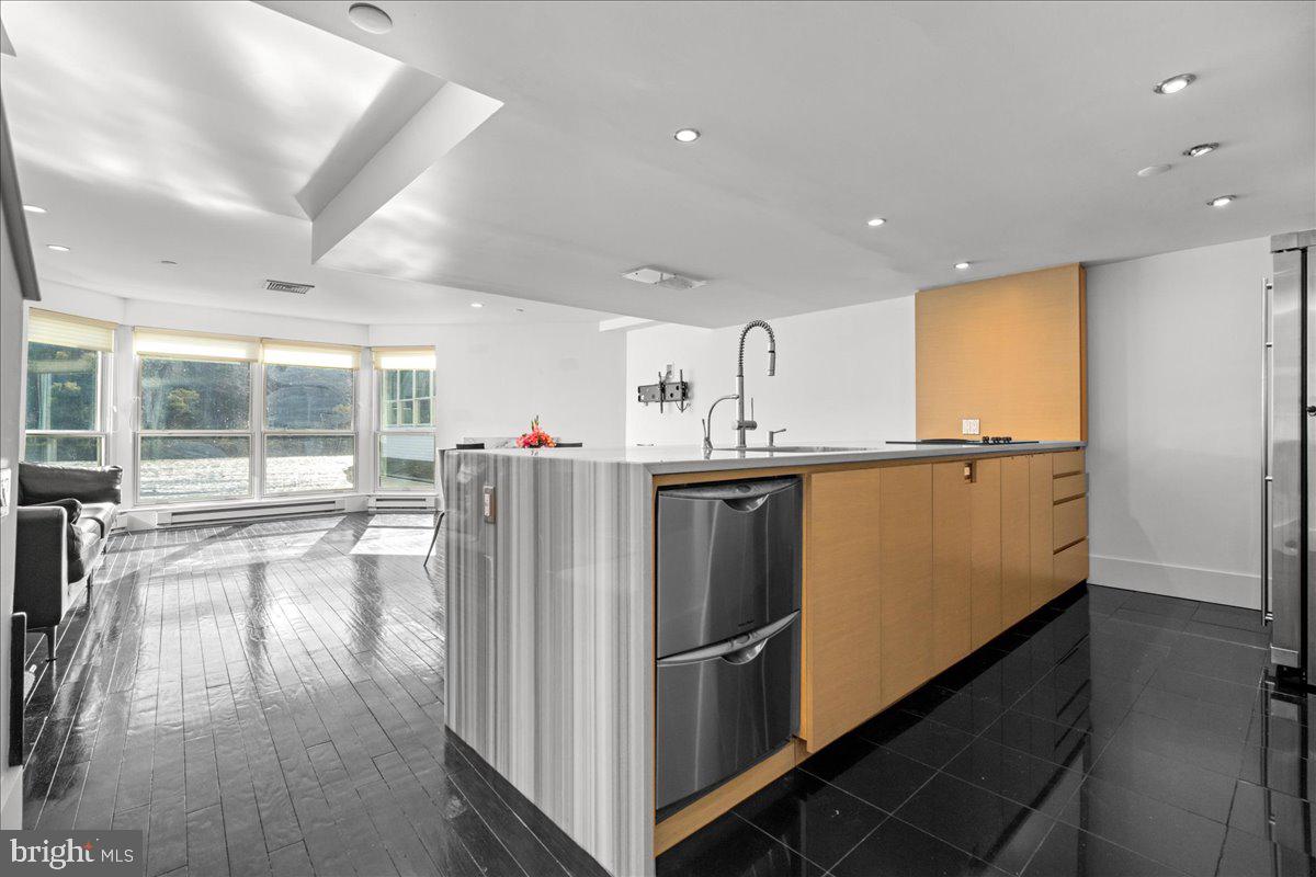 350 River Road, Unit D10 New Hope, PA 18938 - Photo 12 of 41 a kitchen with stainless steel appliances a refrigerator and wooden floor