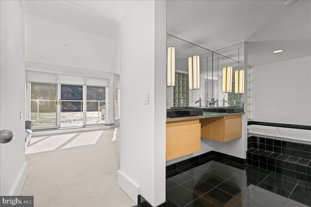 350 River Road, Unit D10 New Hope, PA 18938 - Photo 23 of 41 a bathroom with a granite countertop sink and a large mirror