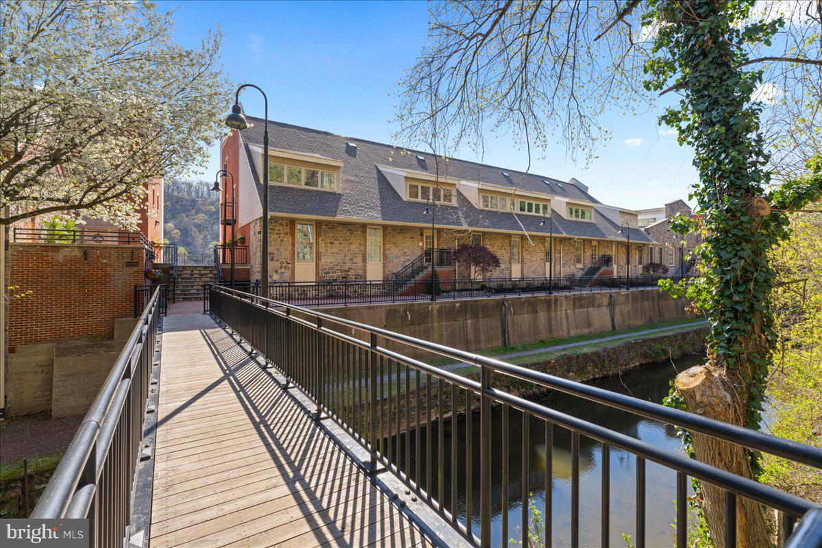 350 River Road, Unit D10 New Hope, PA 18938 - Photo 29 of 41 a view of a balcony with wooden floor and fence