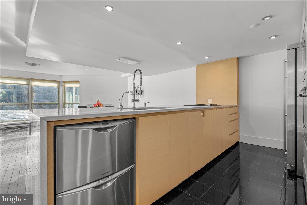 350 River Road, Unit D10 New Hope, PA 18938 - Photo 8 of 41 a kitchen with stainless steel appliances a sink and a refrigerator