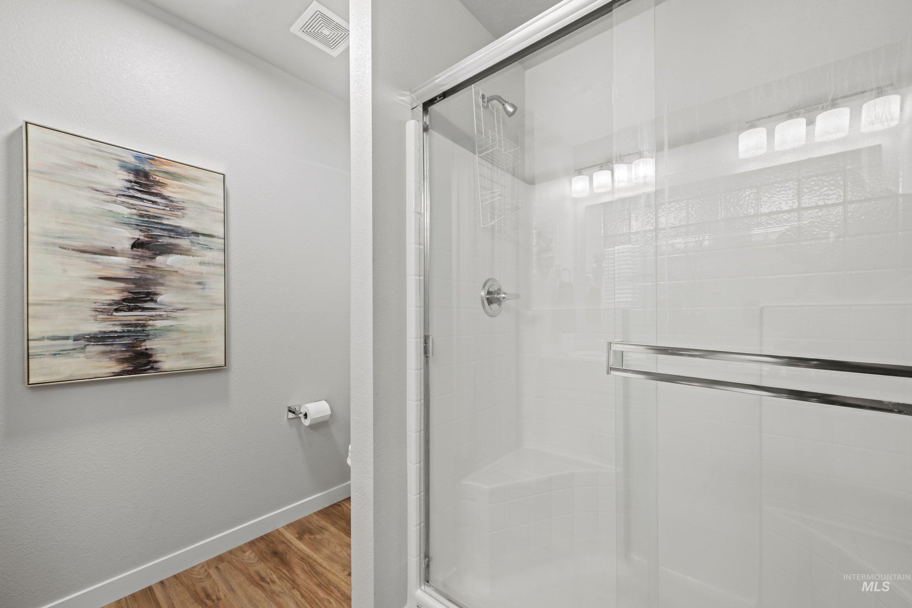 12744 West Fig Street Boise, ID 83713 - Photo 28 of 34 Glass-enclosed shower with a built-in bench and chrome fixtures