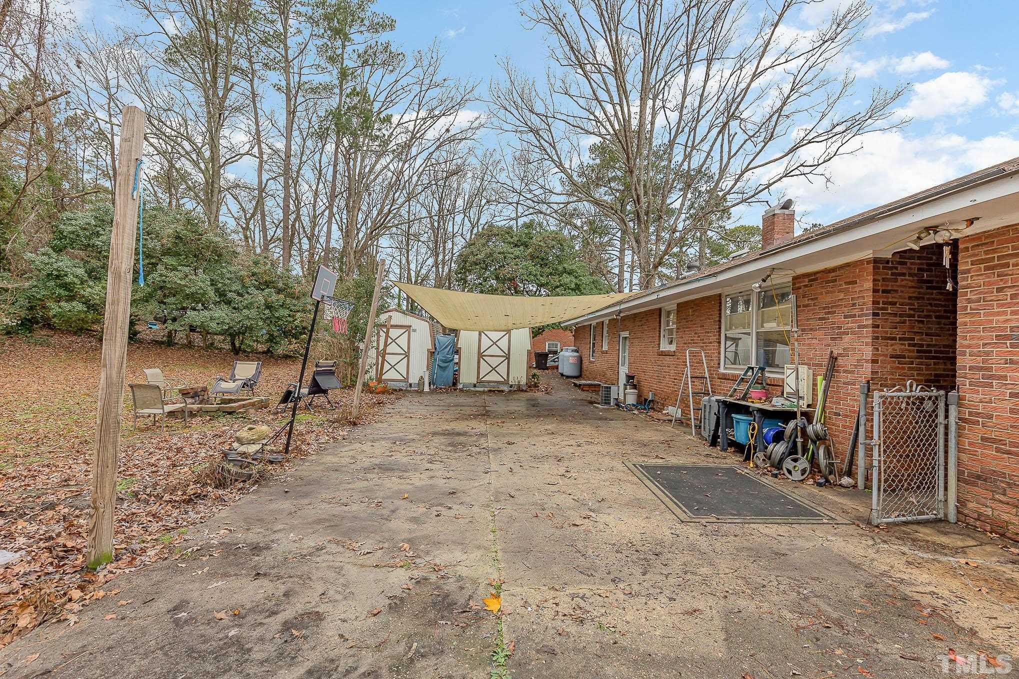 3625 Drayton Road Fayetteville, NC 28303 - Photo 20 of 23 a view of a house with a patio and a backyard