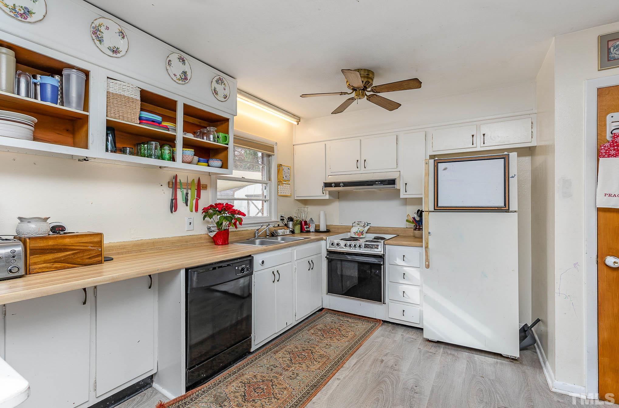 3625 Drayton Road Fayetteville, NC 28303 - Photo 6 of 23 a kitchen with stainless steel appliances granite countertop a refrigerator a stove and a wooden floor