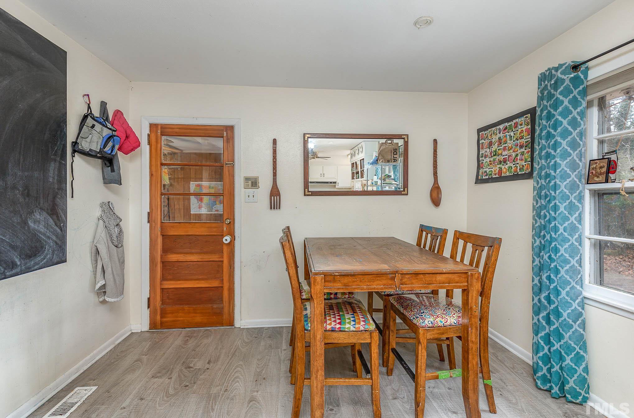 3625 Drayton Road Fayetteville, NC 28303 - Photo 9 of 23 a view of a dining room with furniture and wooden floor