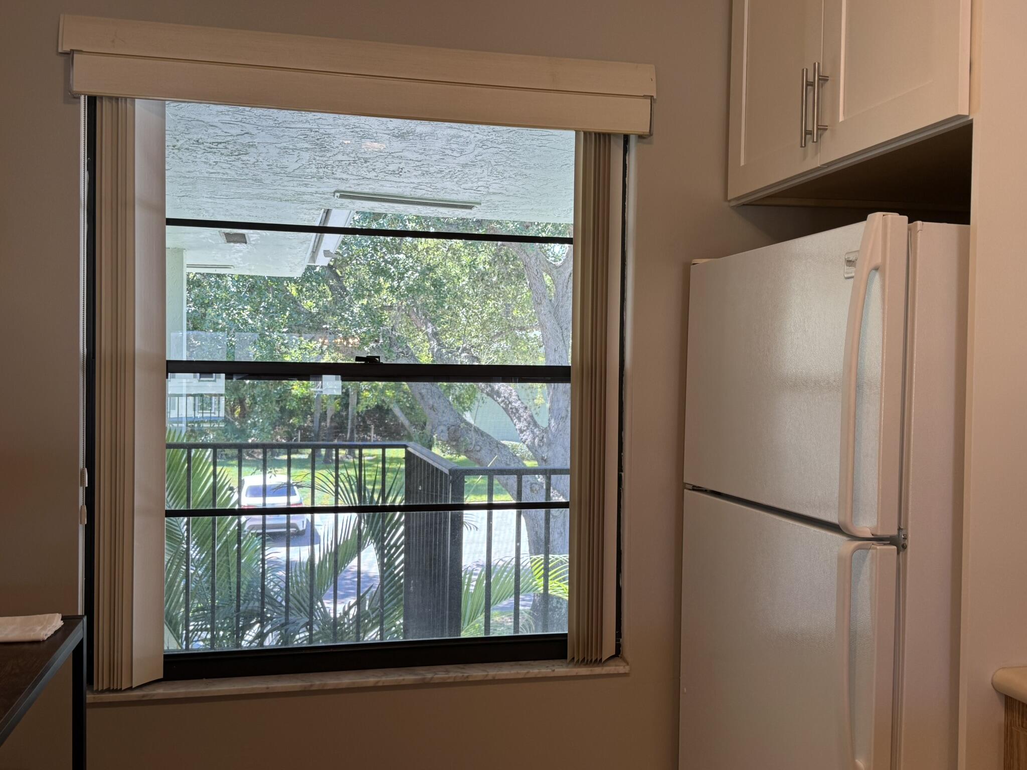 801 Sabal Ridge Circle, Unit H Palm Beach Gardens, FL 33418 - Photo 11 of 42 a white refrigerator freezer sitting inside of a kitchen