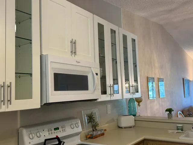 a kitchen with stainless steel appliances granite countertop a sink and a microwave