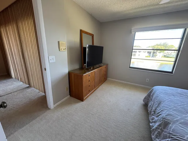 a livingroom with window and a flat screen tv