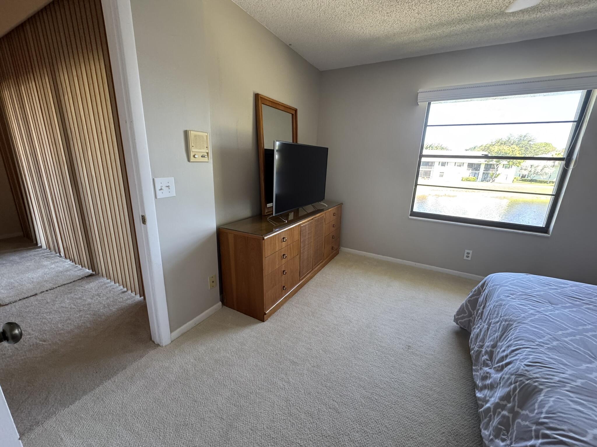 801 Sabal Ridge Circle, Unit H Palm Beach Gardens, FL 33418 - Photo 20 of 42 a livingroom with window and a flat screen tv
