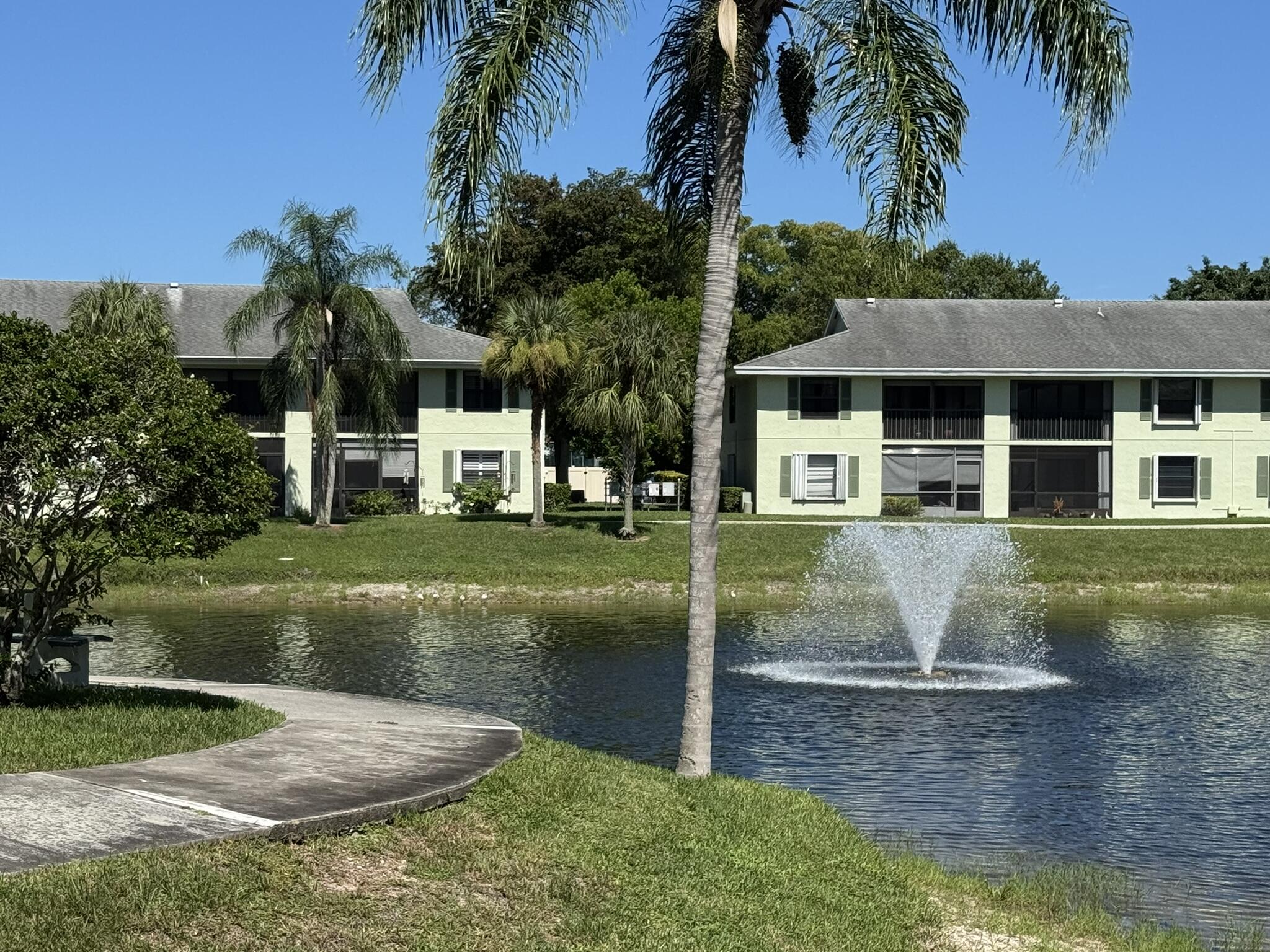 801 Sabal Ridge Circle, Unit H Palm Beach Gardens, FL 33418 - Photo 2 of 42 a view of a house with a yard