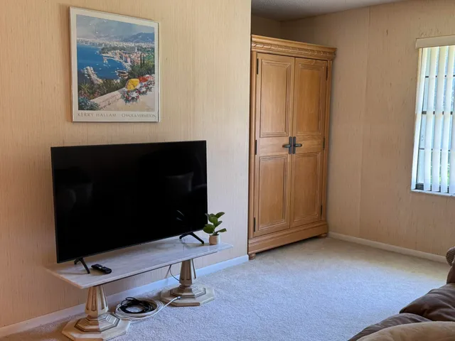 a view of a livingroom with furniture and a flat screen tv