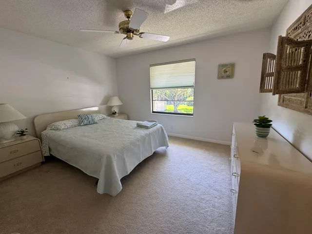 a bedroom with a bed dresser and a window