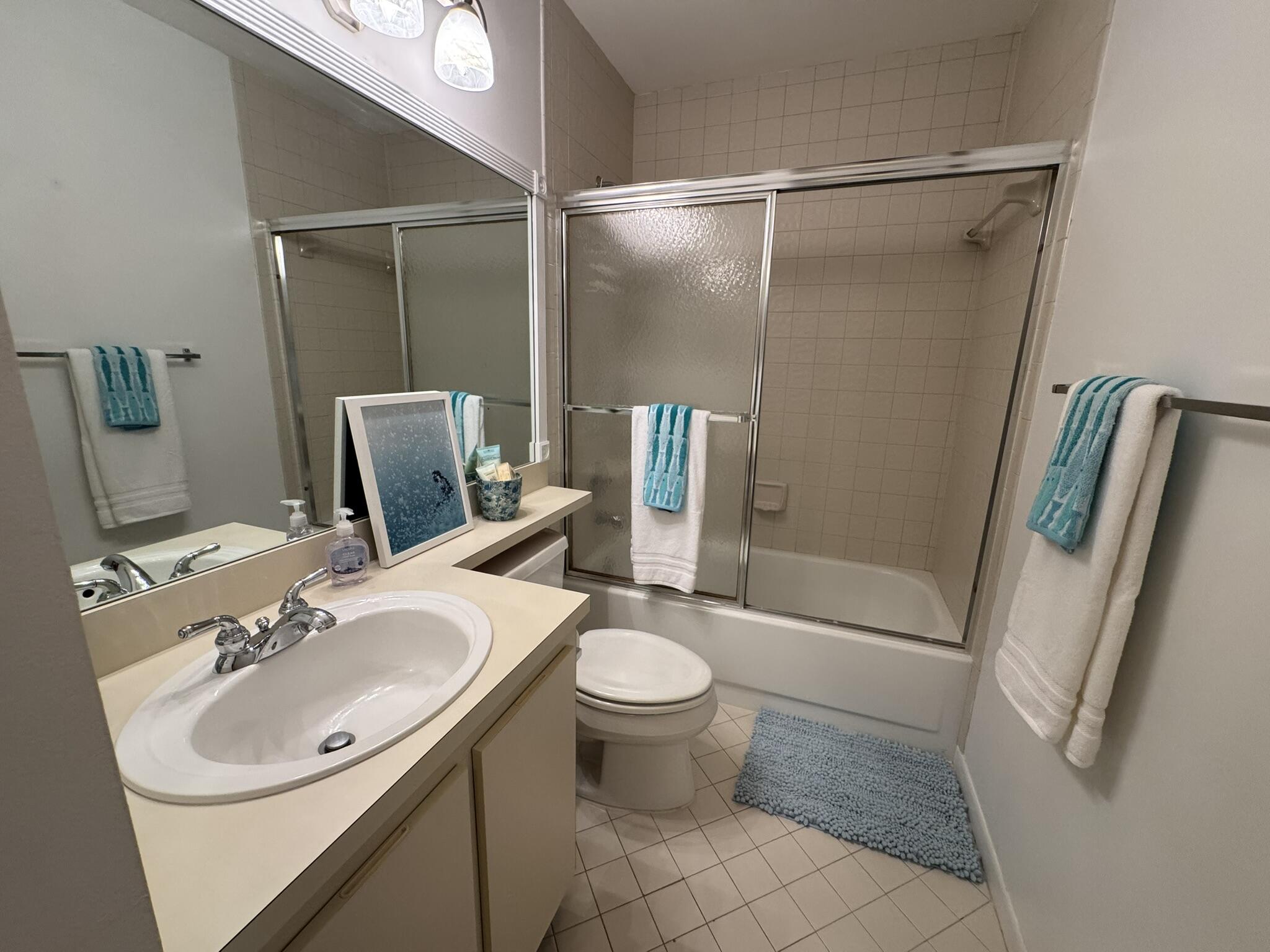 801 Sabal Ridge Circle, Unit H Palm Beach Gardens, FL 33418 - Photo 29 of 42 a bathroom with a sink toilet and shower